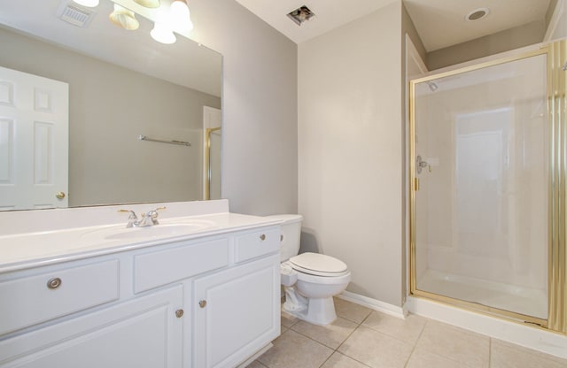 bathroom featuring a shower with door, vanity, toilet, and tile patterned floors