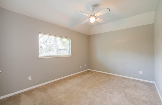 unfurnished room featuring a ceiling fan, baseboards, and light carpet