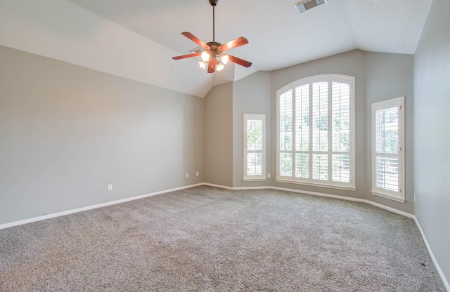 spare room featuring vaulted ceiling, a ceiling fan, visible vents, and carpet