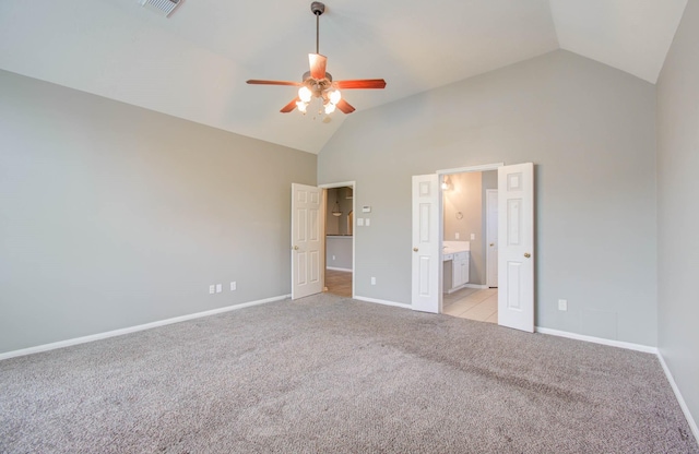 unfurnished bedroom with high vaulted ceiling, a ceiling fan, ensuite bath, light colored carpet, and baseboards