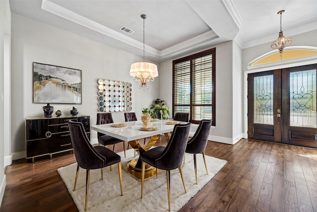 dining room with french doors, a tray ceiling, crown molding, a chandelier, and dark hardwood / wood-style floors