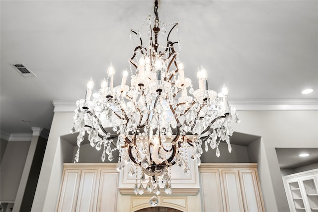 interior details with crown molding and a notable chandelier