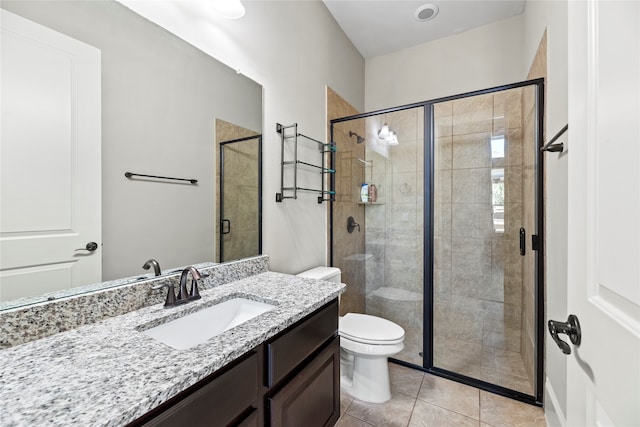 bathroom featuring vanity, toilet, tile patterned floors, and a shower with door