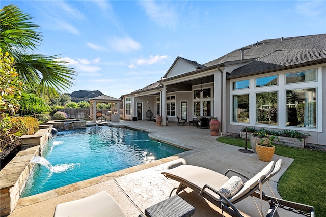 view of swimming pool featuring a patio area, pool water feature, and ceiling fan