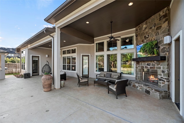 view of patio / terrace featuring an outdoor living space with a fireplace and ceiling fan