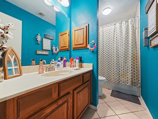 bathroom featuring a textured ceiling, toilet, vanity, curtained shower, and tile patterned flooring