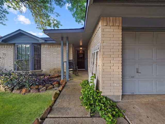 doorway to property with a garage