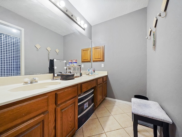 bathroom featuring vanity, a textured ceiling, and tile patterned flooring