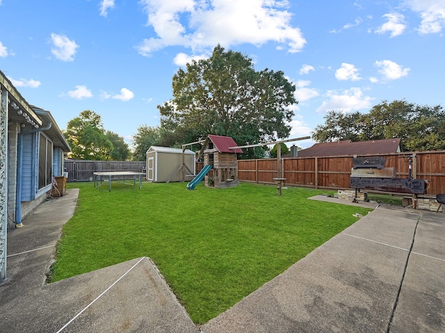 view of yard with a shed, a patio, and a playground