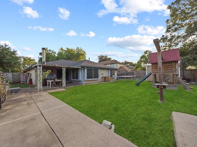 view of yard with a patio area and a playground