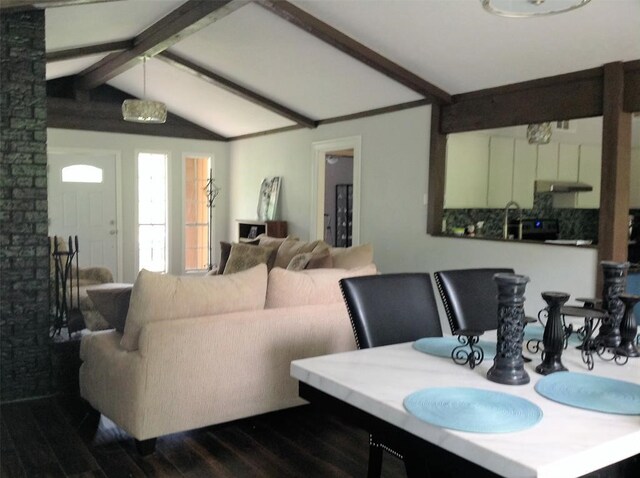 dining space with vaulted ceiling with beams, sink, and dark wood-type flooring