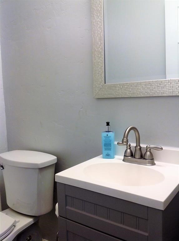 bathroom featuring toilet and vanity