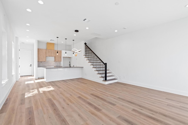 unfurnished living room with light hardwood / wood-style floors