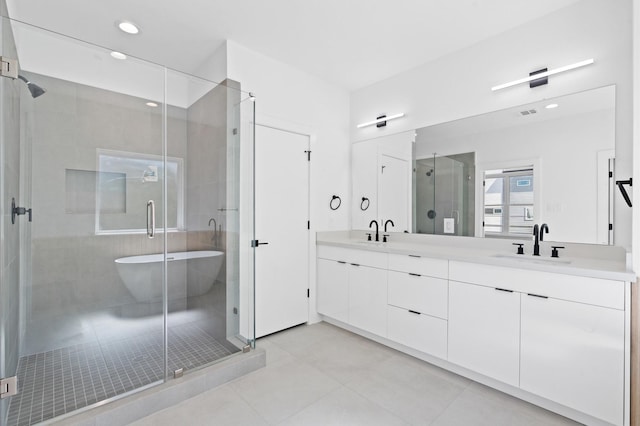 bathroom with tile patterned flooring, shower with separate bathtub, and vanity