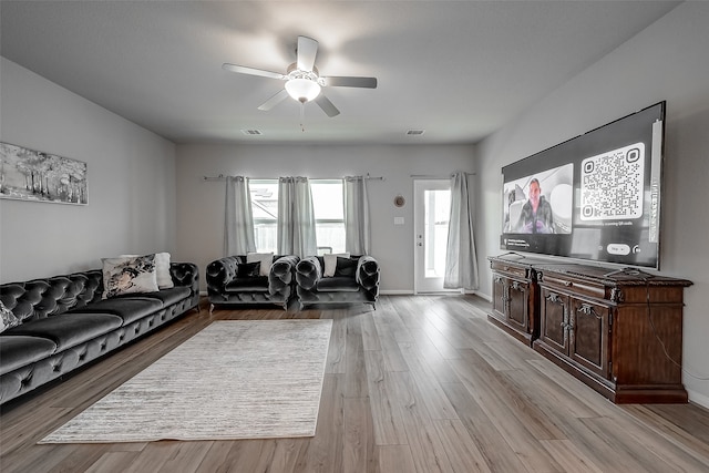 living room featuring light wood-type flooring and ceiling fan