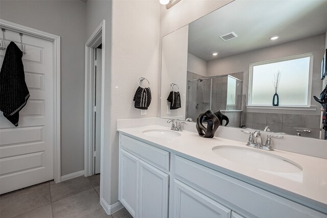 bathroom featuring vanity, tile patterned floors, and an enclosed shower