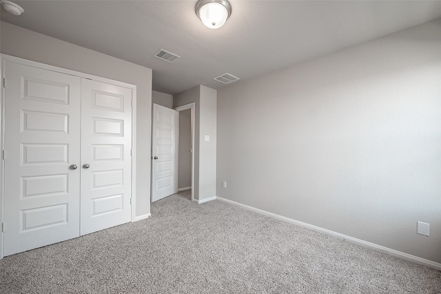 unfurnished bedroom featuring a closet and carpet