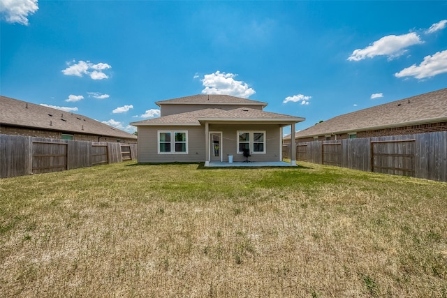 rear view of house featuring a patio and a lawn