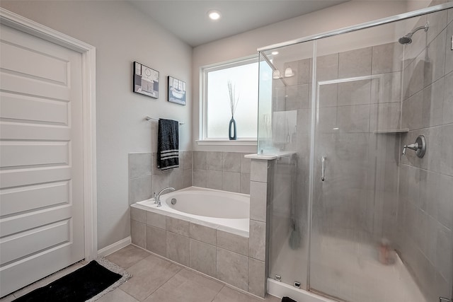 bathroom with independent shower and bath and tile patterned floors