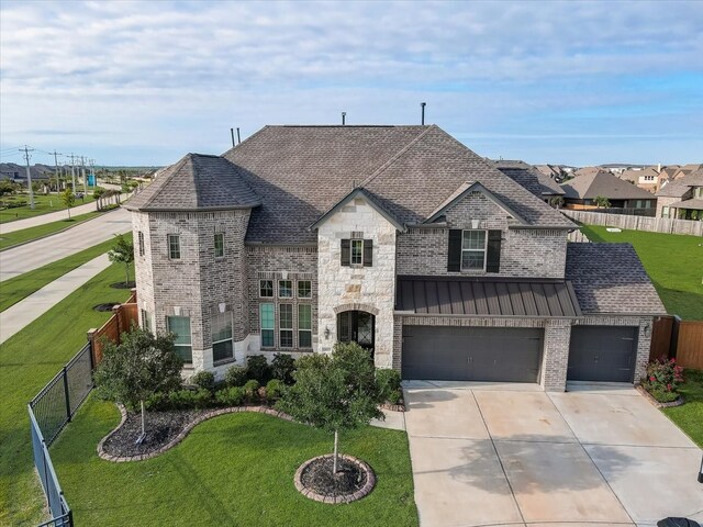 french country inspired facade featuring a front yard