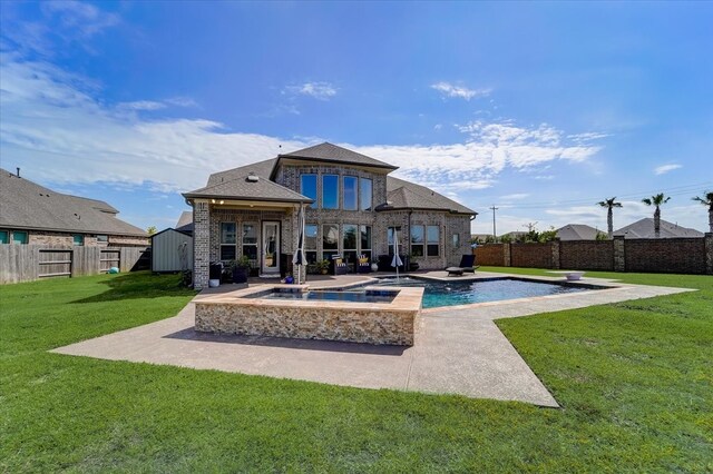 back of property featuring a patio area, a pool with hot tub, and a lawn