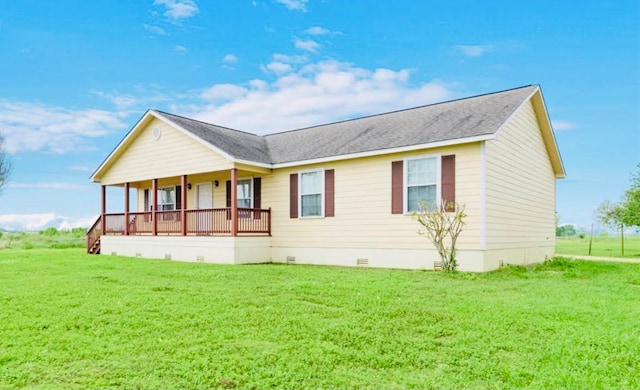 back of house featuring a yard and covered porch