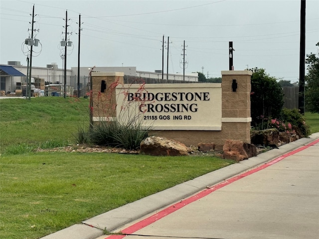 community / neighborhood sign with a lawn