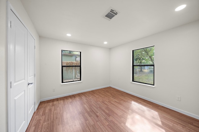 unfurnished bedroom featuring hardwood / wood-style floors and a closet