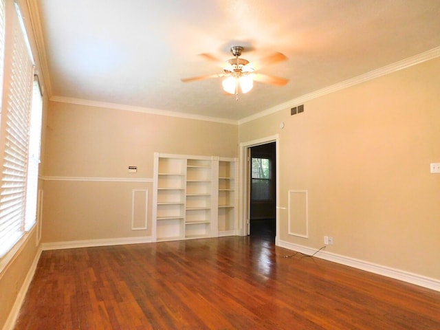 spare room with ceiling fan, crown molding, and dark hardwood / wood-style floors