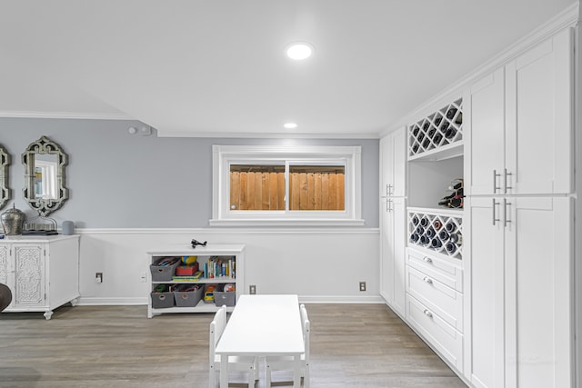 interior space featuring light hardwood / wood-style floors and ornamental molding