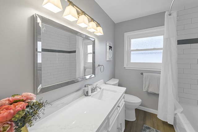 full bathroom with vanity, toilet, hardwood / wood-style flooring, and shower / bath combo