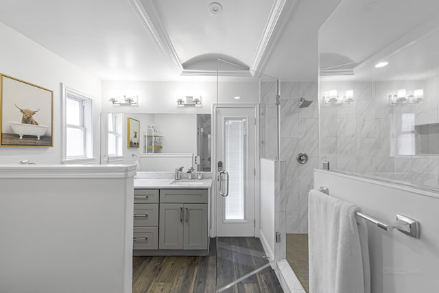 bathroom with vanity, an enclosed shower, wood-type flooring, and crown molding