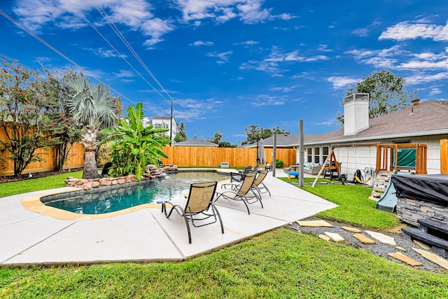 view of pool with a yard and a patio