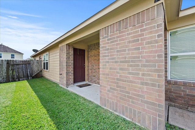 property entrance featuring a lawn