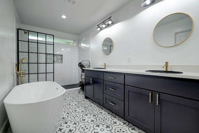 bathroom featuring vanity, plus walk in shower, and tile patterned flooring