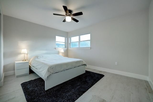 bedroom with light hardwood / wood-style flooring and ceiling fan