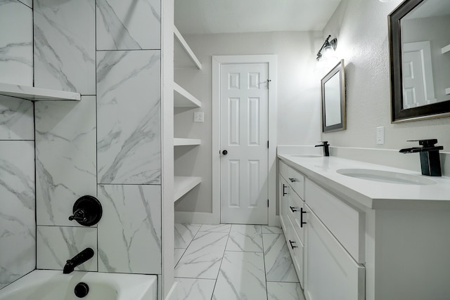 bathroom featuring tiled shower / bath, vanity, and built in features