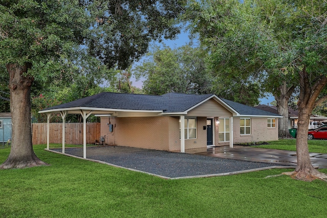 ranch-style house with a front yard and a carport