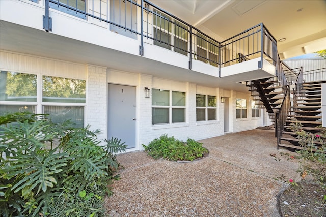 view of exterior entry with a patio area