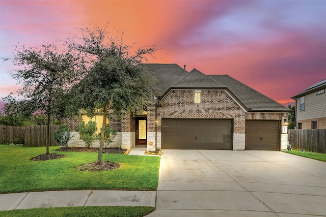 view of front of home featuring a yard and a garage