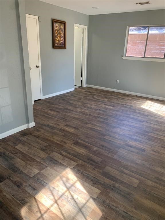 unfurnished room featuring dark hardwood / wood-style flooring