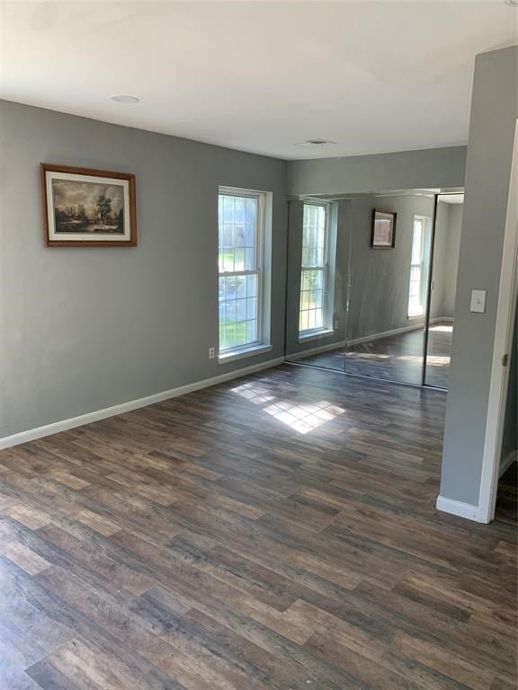 unfurnished room with dark hardwood / wood-style floors