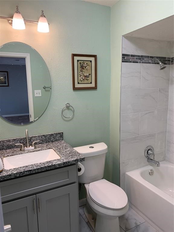 full bathroom featuring toilet, tiled shower / bath combo, and vanity