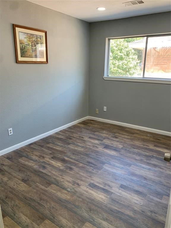 spare room featuring dark hardwood / wood-style floors