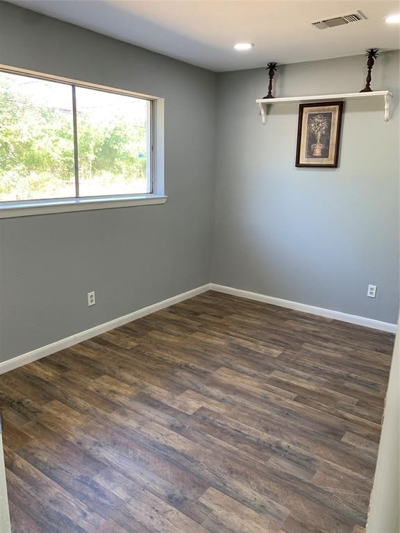 empty room with dark wood-type flooring