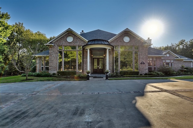 851 Elm Dr, Brenham, TX 77833 - view of front of property with french doors, a chimney, and brick siding