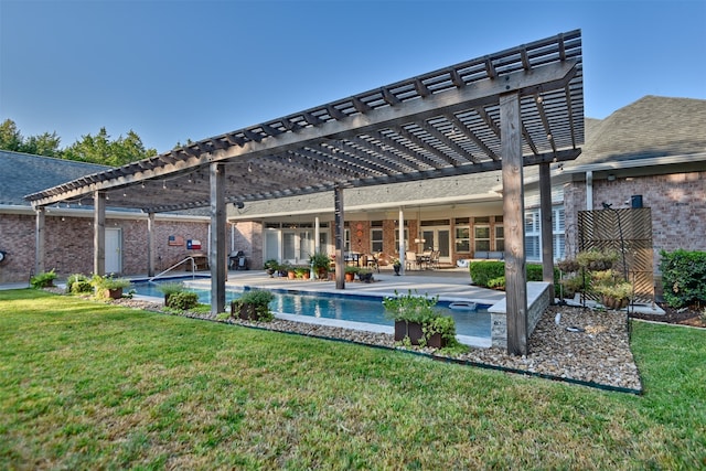 rear view of house with a patio, a pergola, and a yard