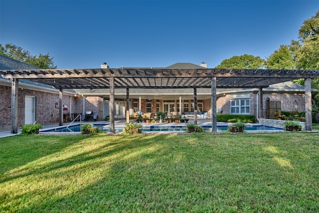 back of house featuring a yard, a patio, and a pergola