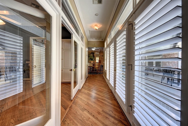 851 Elm Dr, Brenham, TX 77833 - hallway featuring attic access, light wood-style floors, and crown molding