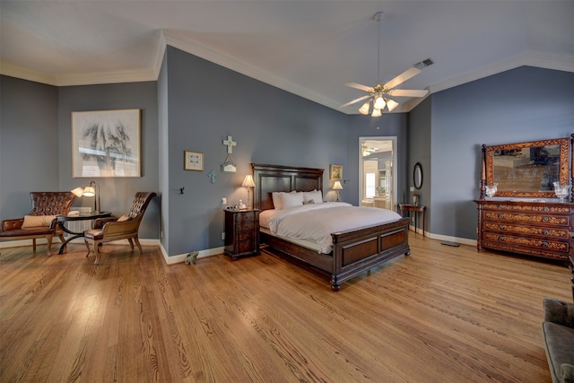 bedroom featuring ornamental molding, vaulted ceiling, light wood-type flooring, and ceiling fan